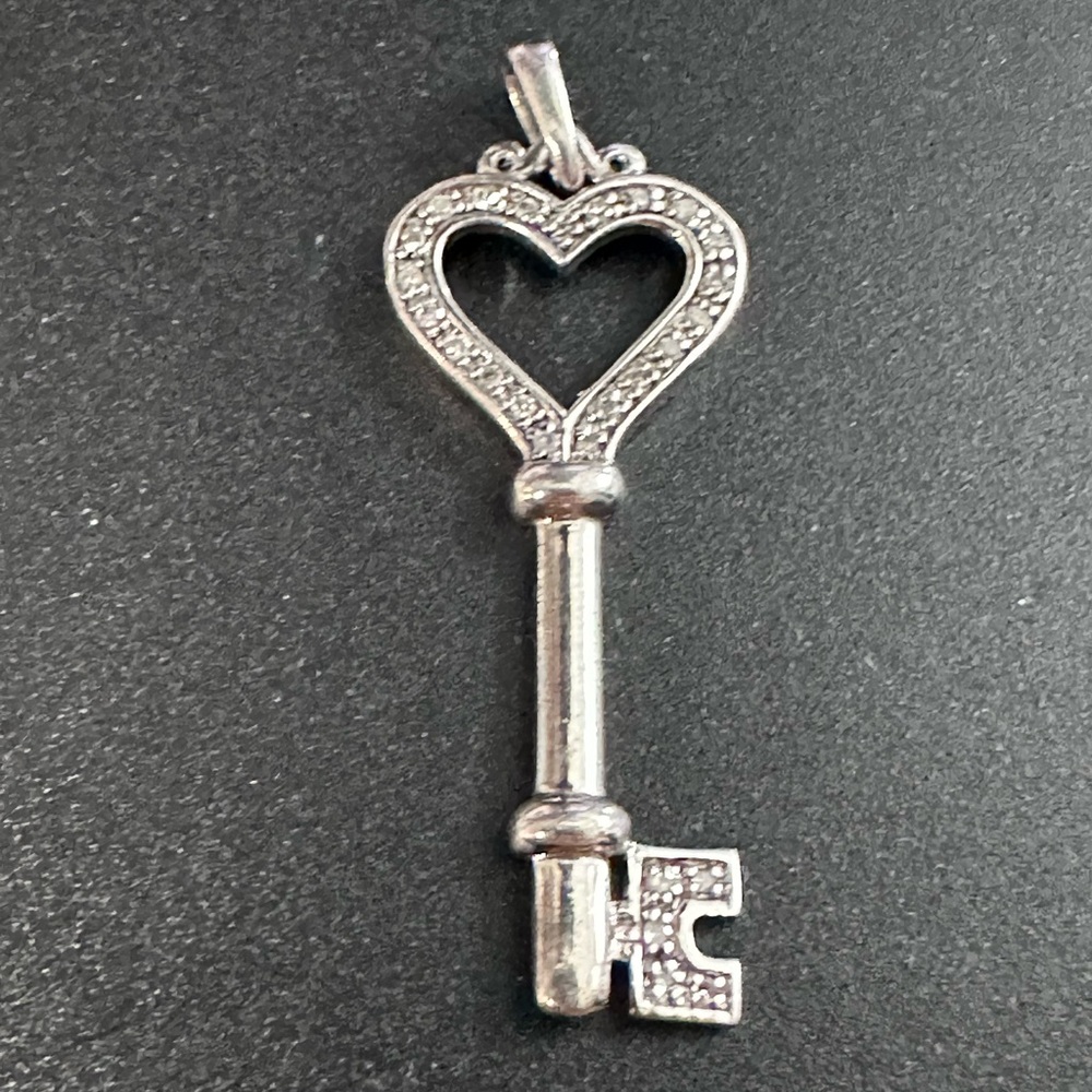 18A- 925 Heart Key Pendant with clear stones not tested. No chain included.